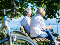Senior woman and man at rest on bike trip