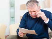 Senior at home receiving negative message