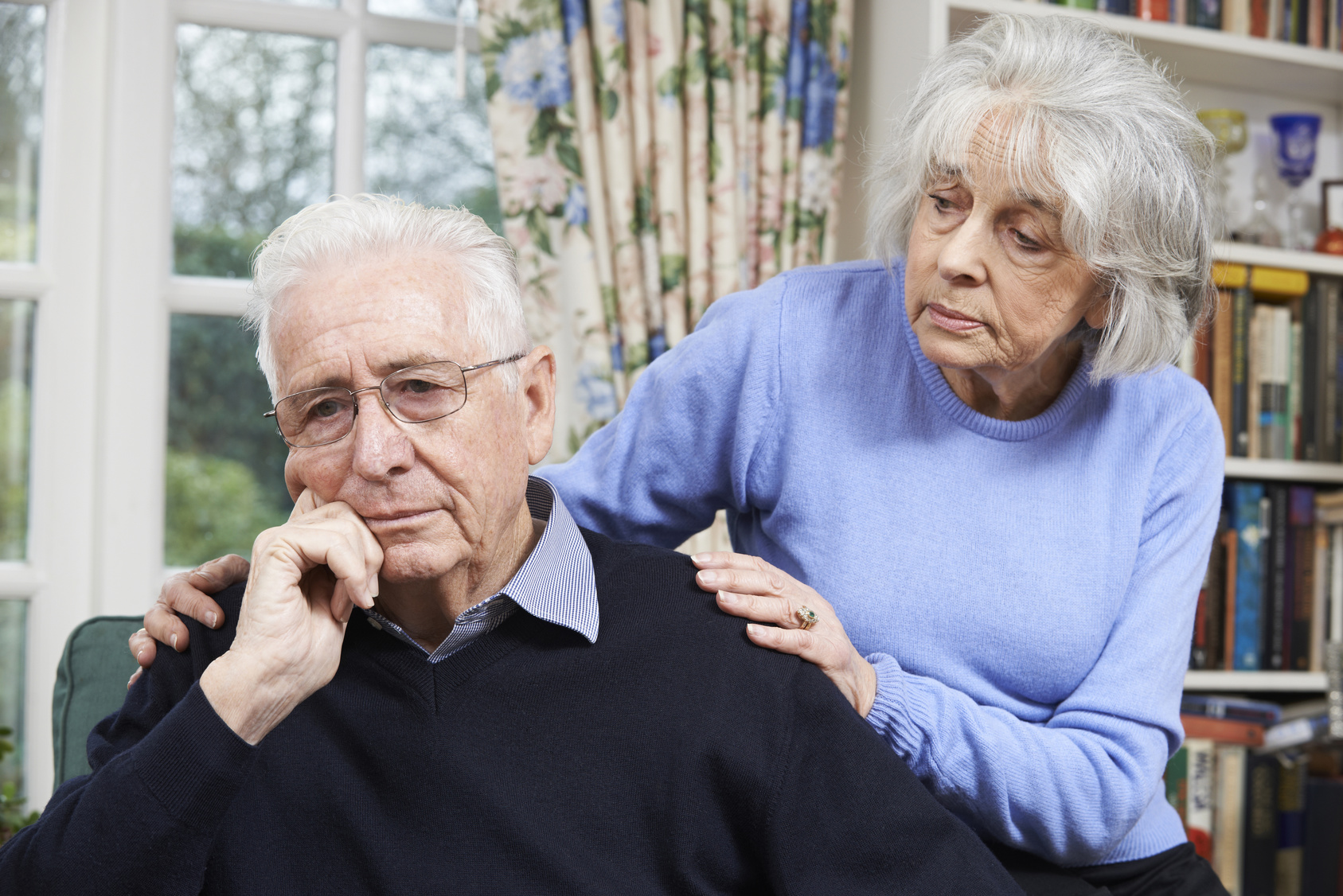 Woman Comforting Senior Man With Depression