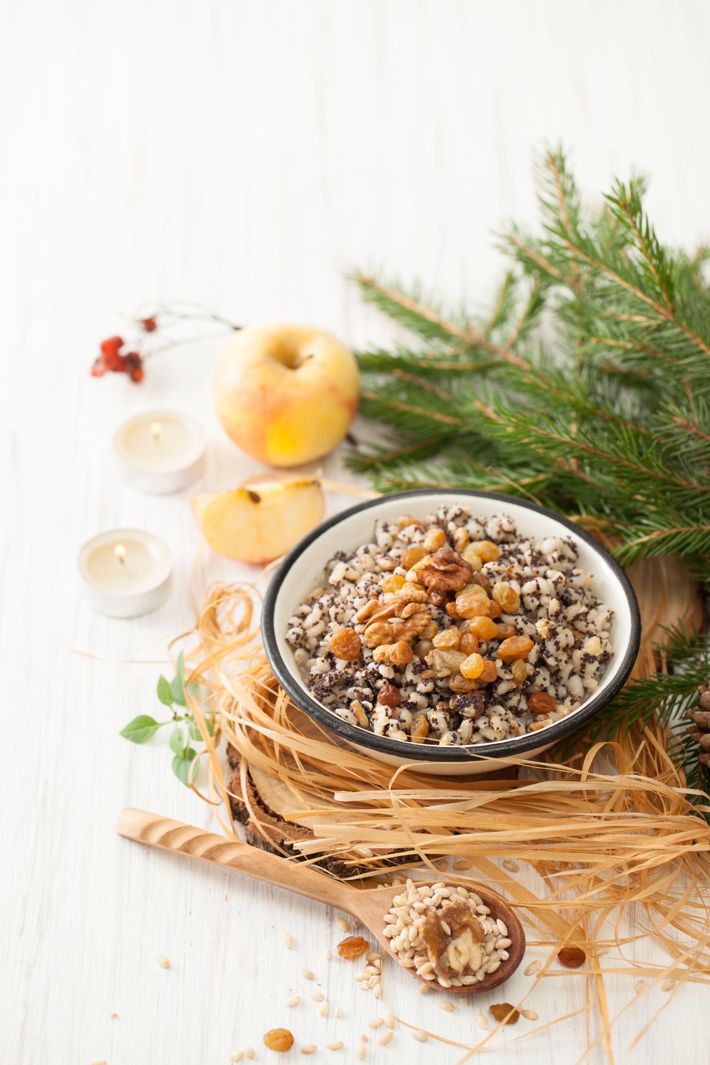 Christmas porridge with a fur-tree branch on a white table